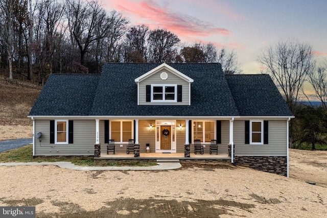 cape cod home with a porch