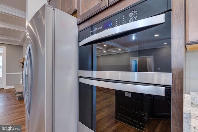 room details featuring wine cooler, stainless steel appliances, dark hardwood / wood-style floors, and ornamental molding