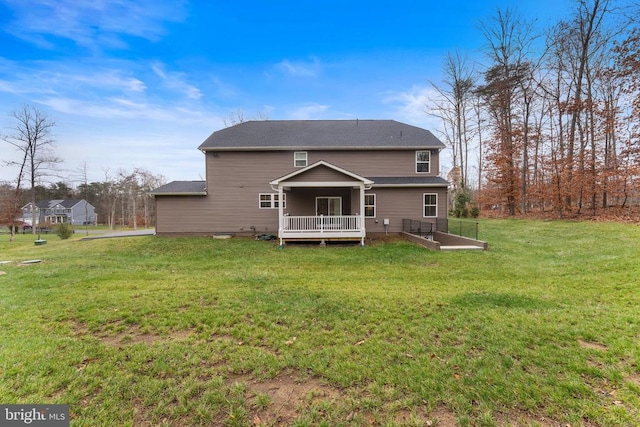 rear view of property with a lawn