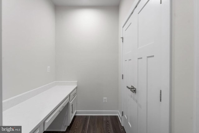 laundry area with dark hardwood / wood-style flooring