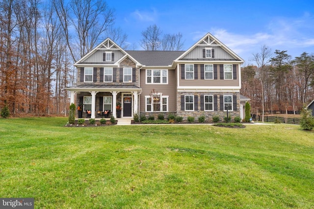 craftsman inspired home with a porch and a front yard