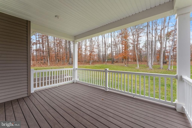 wooden terrace featuring a lawn