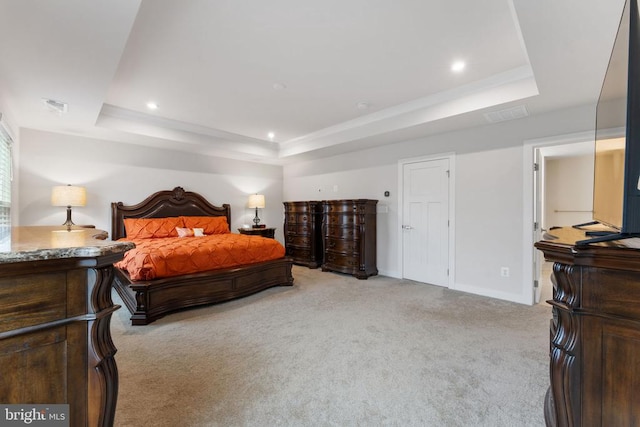 bedroom featuring a tray ceiling and light colored carpet