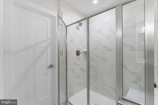 bathroom featuring a shower with door