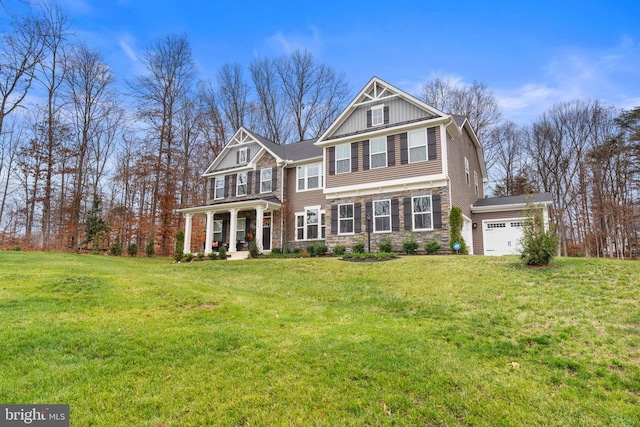 view of front of property with a porch, a garage, and a front yard