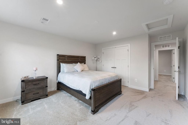 bedroom featuring light colored carpet and a closet