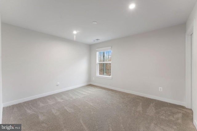 spare room with light carpet