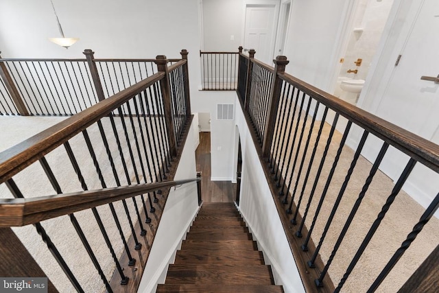 staircase featuring hardwood / wood-style floors