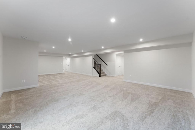 basement featuring light colored carpet