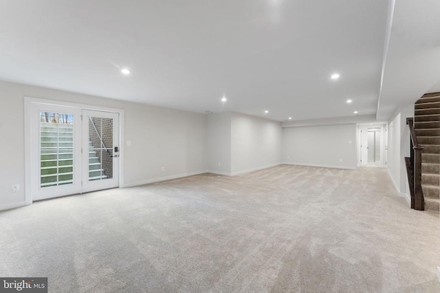 unfurnished living room featuring light colored carpet