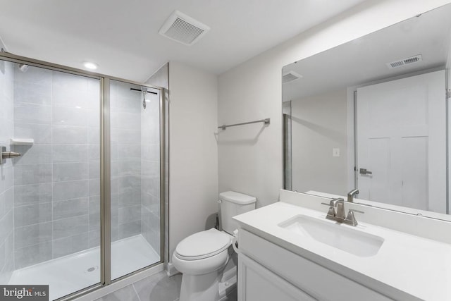 bathroom featuring a shower with door, vanity, and toilet