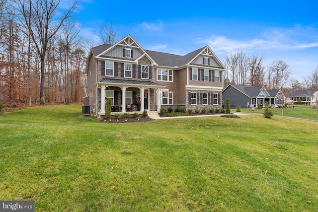 view of front of property with central AC unit, covered porch, and a front yard