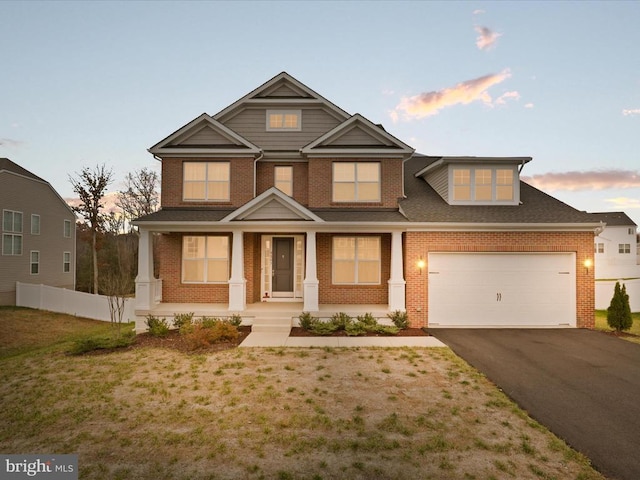 view of front of home featuring a porch and a garage