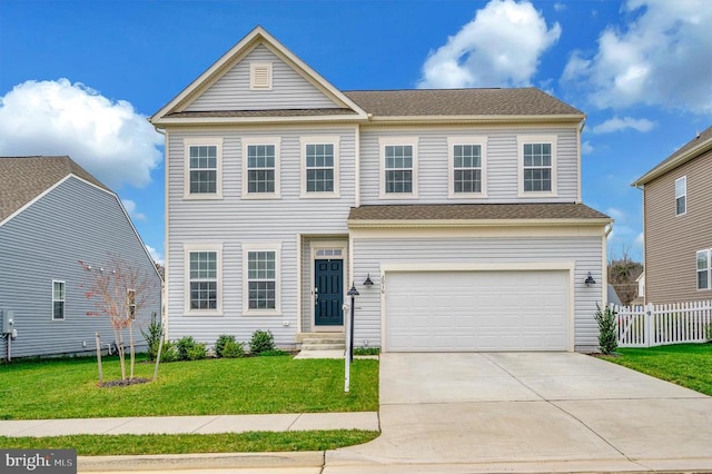 view of front of property featuring a garage and a front lawn