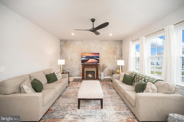 living room featuring hardwood / wood-style floors and ceiling fan