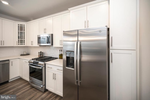 kitchen featuring backsplash, dark hardwood / wood-style flooring, white cabinetry, and stainless steel appliances