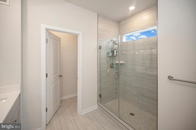 bathroom featuring tile patterned floors, vanity, and walk in shower