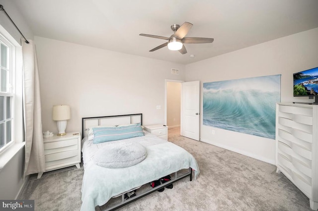 bedroom featuring ceiling fan and carpet