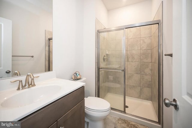 bathroom with an enclosed shower, vanity, and toilet