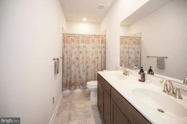 bathroom with tile patterned flooring, vanity, and toilet