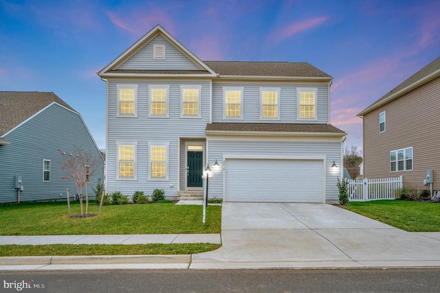 view of front of property with a lawn and a garage