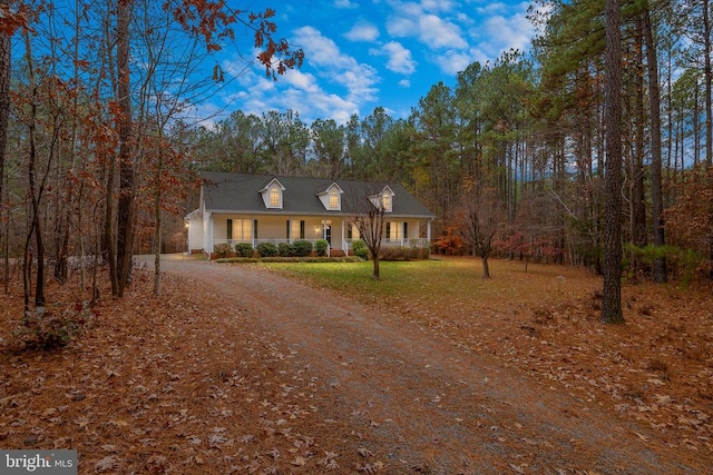 new england style home featuring a porch