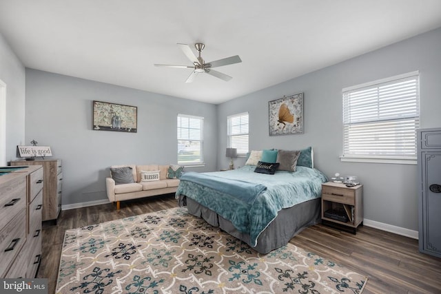 bedroom with dark hardwood / wood-style floors and ceiling fan