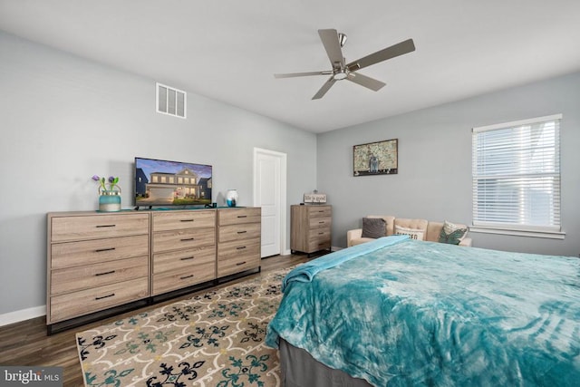 bedroom with ceiling fan and dark wood-type flooring