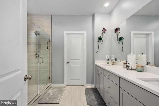 bathroom with tile patterned flooring, vanity, and an enclosed shower