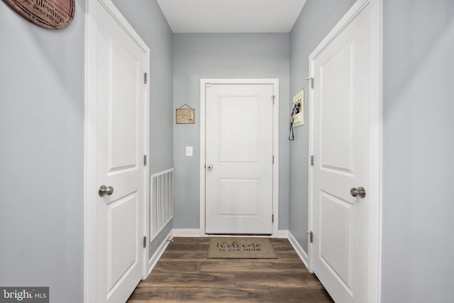 doorway with dark wood-type flooring