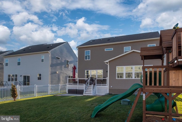 rear view of house with a playground and a lawn