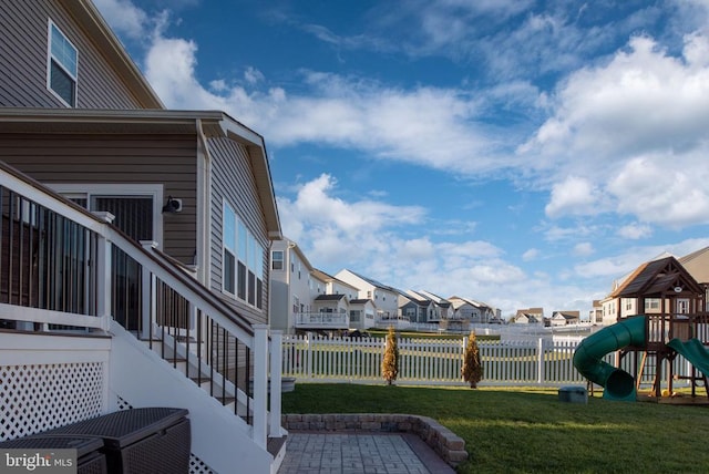 view of yard featuring a patio and a playground