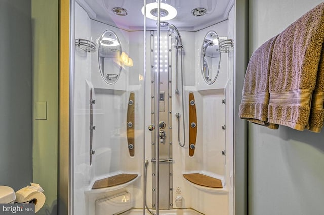 bathroom with a shower with shower door