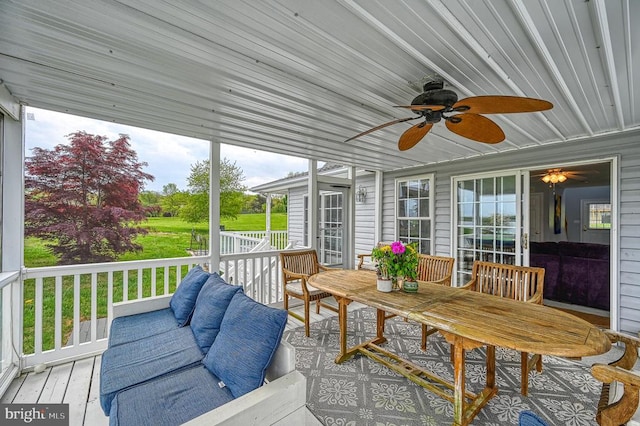 sunroom / solarium featuring ceiling fan