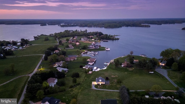 aerial view at dusk with a water view