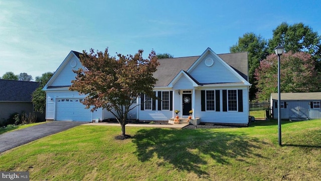 view of front facade with a front yard and a garage