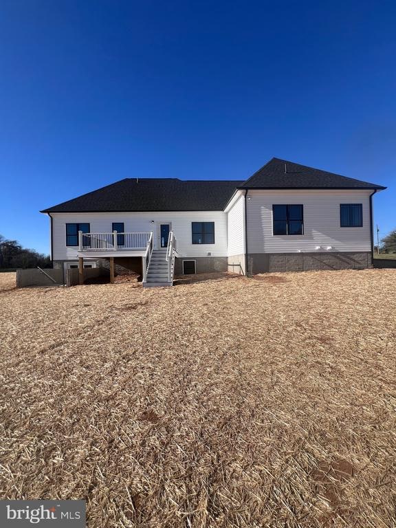 back of house featuring a wooden deck