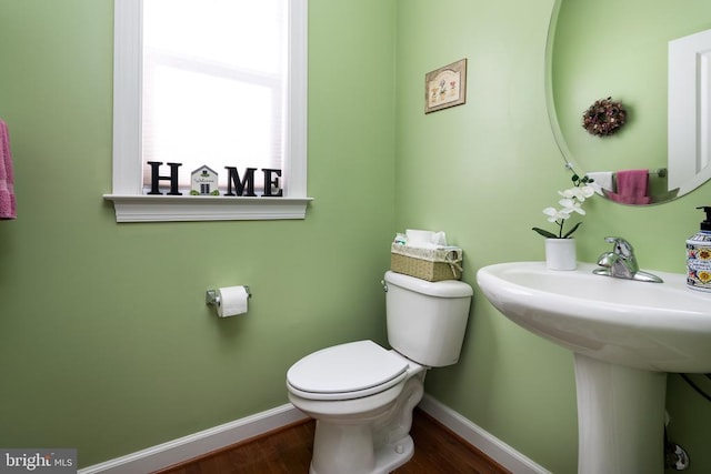 bathroom featuring hardwood / wood-style flooring and toilet