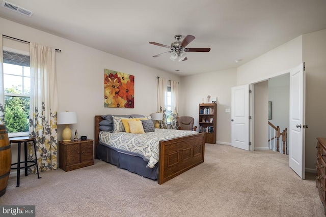 bedroom featuring light carpet and ceiling fan