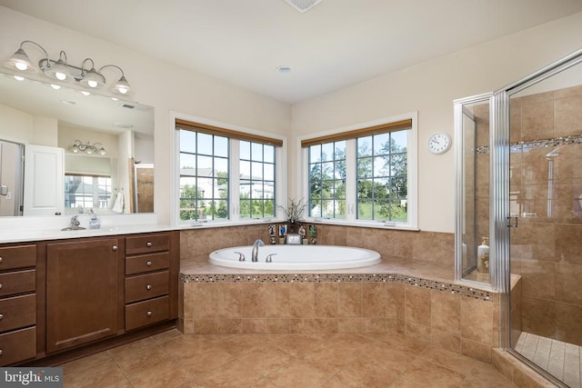 bathroom featuring tile patterned flooring, plenty of natural light, and plus walk in shower