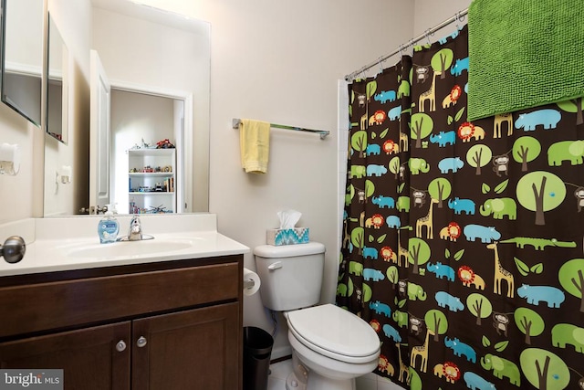 bathroom with tile patterned floors, vanity, toilet, and curtained shower