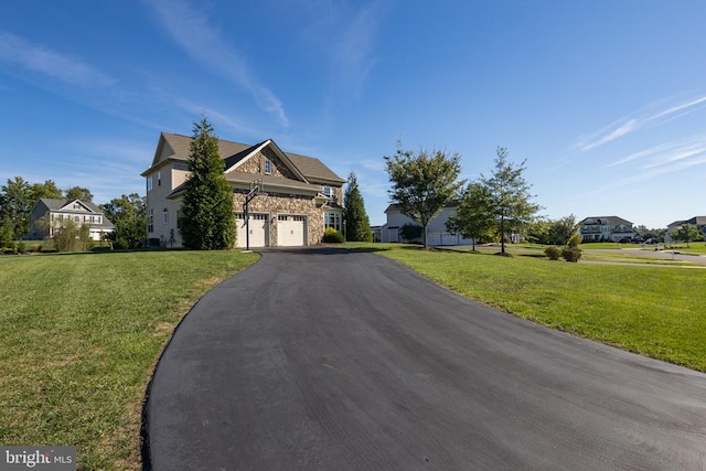 view of front of house with a garage and a front lawn