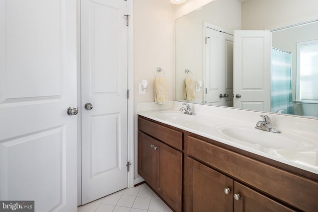 bathroom with tile patterned flooring and vanity