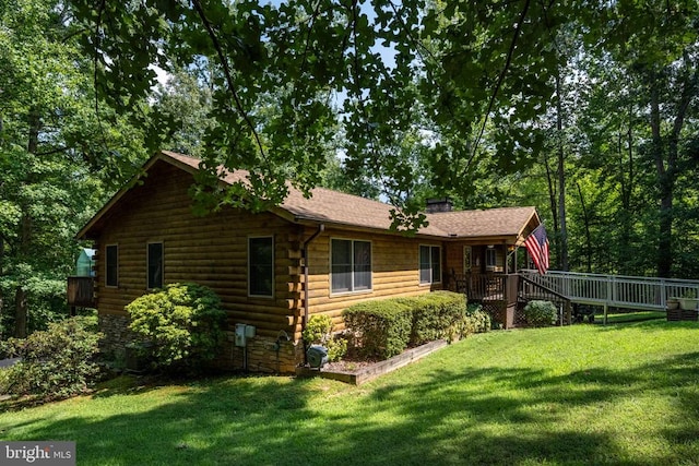 back of property featuring a deck and a yard