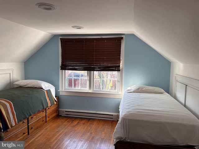 bedroom with a baseboard radiator, vaulted ceiling, and hardwood / wood-style flooring