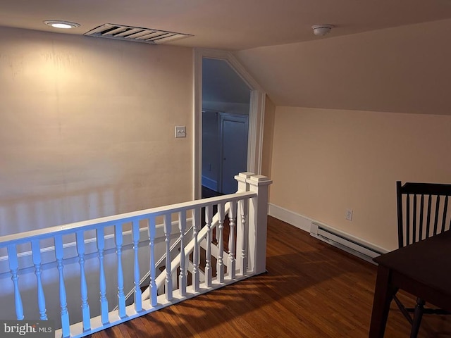 corridor with a baseboard radiator, vaulted ceiling, and dark wood-type flooring