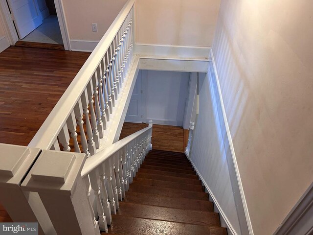 stairs featuring wood-type flooring