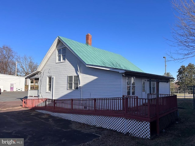 back of house with a wooden deck