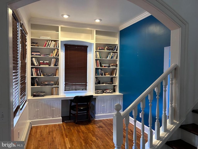 unfurnished office with crown molding, built in desk, a baseboard radiator, and dark hardwood / wood-style floors