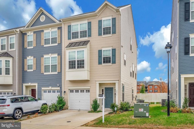 view of property featuring a front lawn and a garage